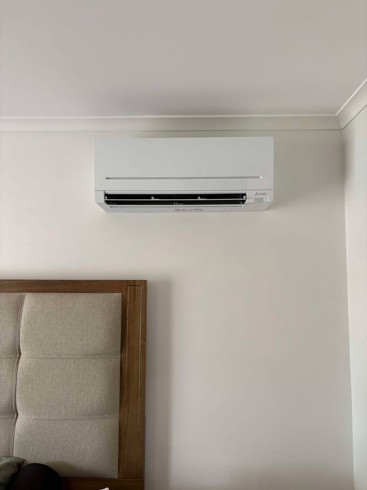Split system above a bed in a bedroom