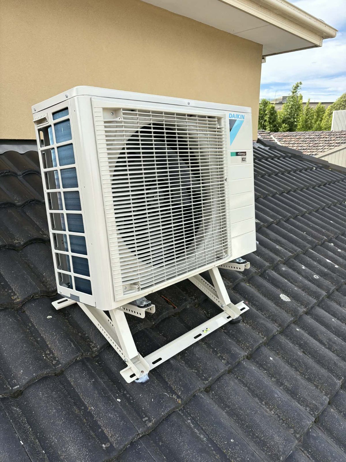 Daikin outdoor unit on a roof bracket