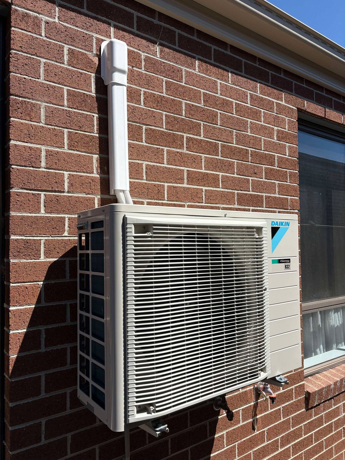Daikin outdoor unit on a brick wall