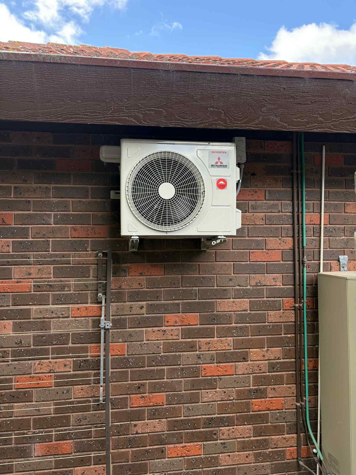 Mitsubishi Heavy Industries outdoor unit on a brick wall